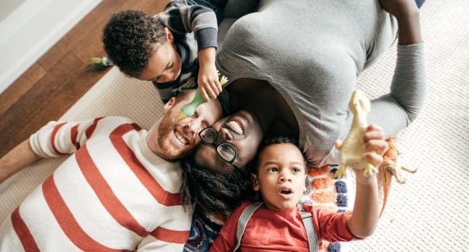 Mom and dad playing with young children